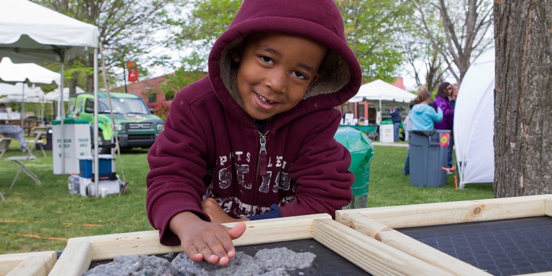 A child plays outside at Temple s Earth Fest.