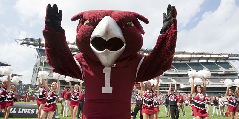 Hooter and the Spirit Squad on a football field.