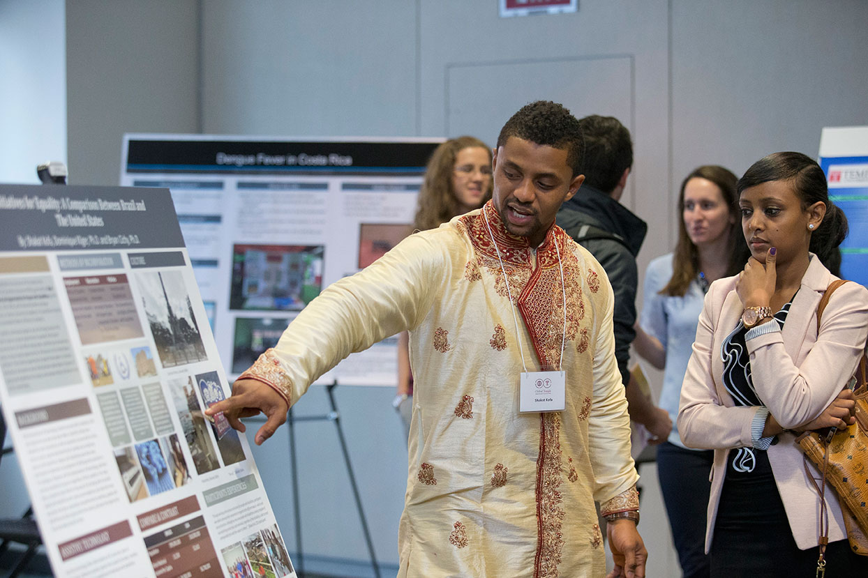 student presents a poster at Global Temple 2014