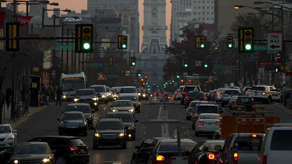 Two students waiting for a train at Temple University s SEPTA Regional Rail Station as a train passes by.