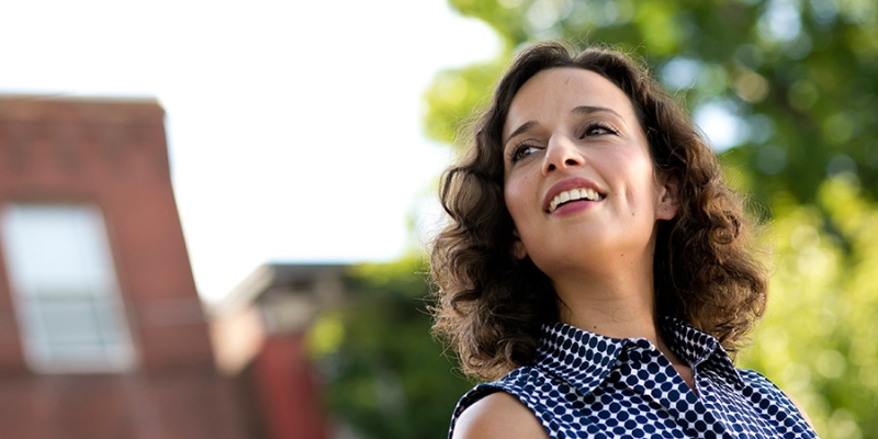 Yasmine Mustafa outside, looking into the distance.