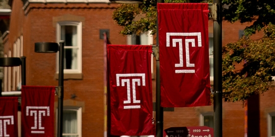 Four Temple T flags on Main Campus.