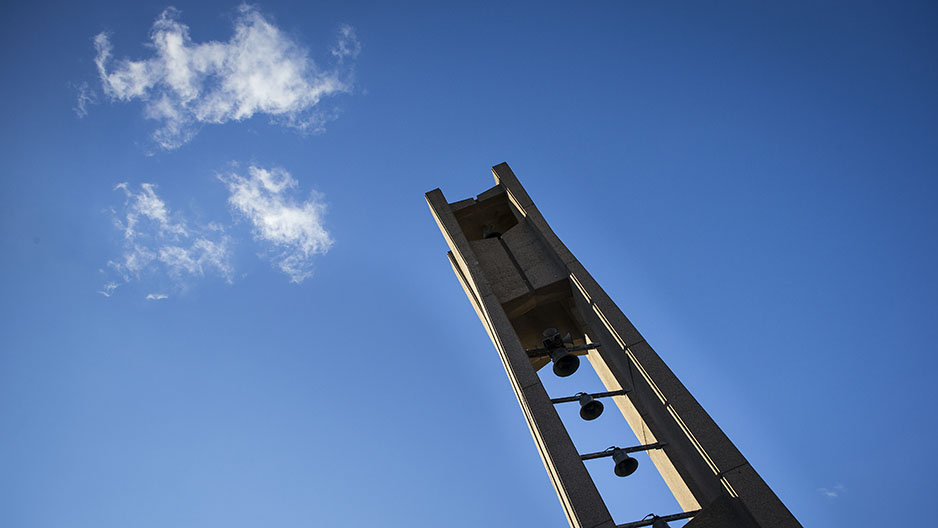 The Bell Tower and a bright blue sky with a few white clouds in the background.