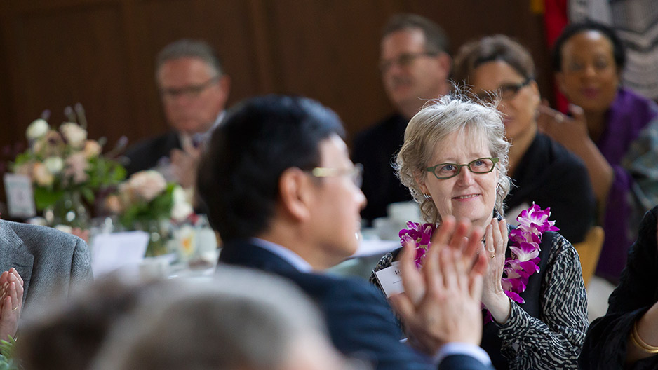A female faculty member applauding during Temple s Faculty Awards Luncheon.