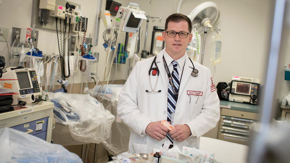 Dr. Joseph D Orazio holding naloxone in a trauma bay at Temple Hospital.