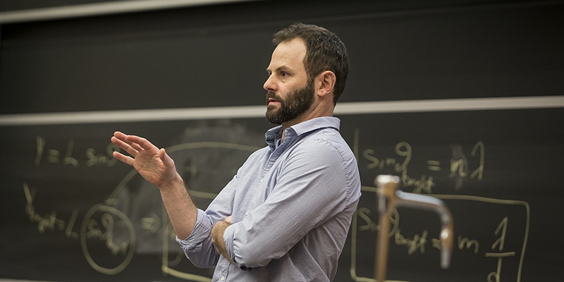 Erik Cordes leading a lecture in front of a chalkboard.