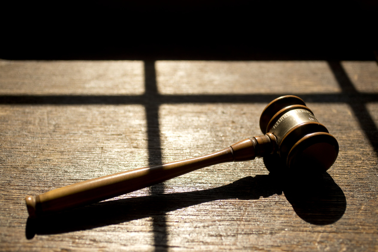 A gavel rests in a patch of sunlight.