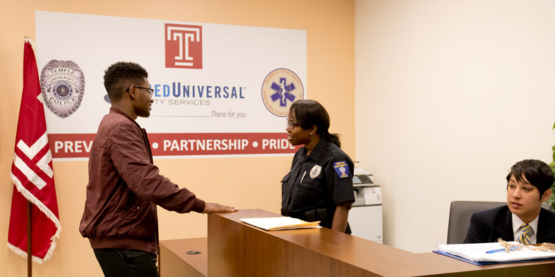 A man talking with a police officer inside the new station