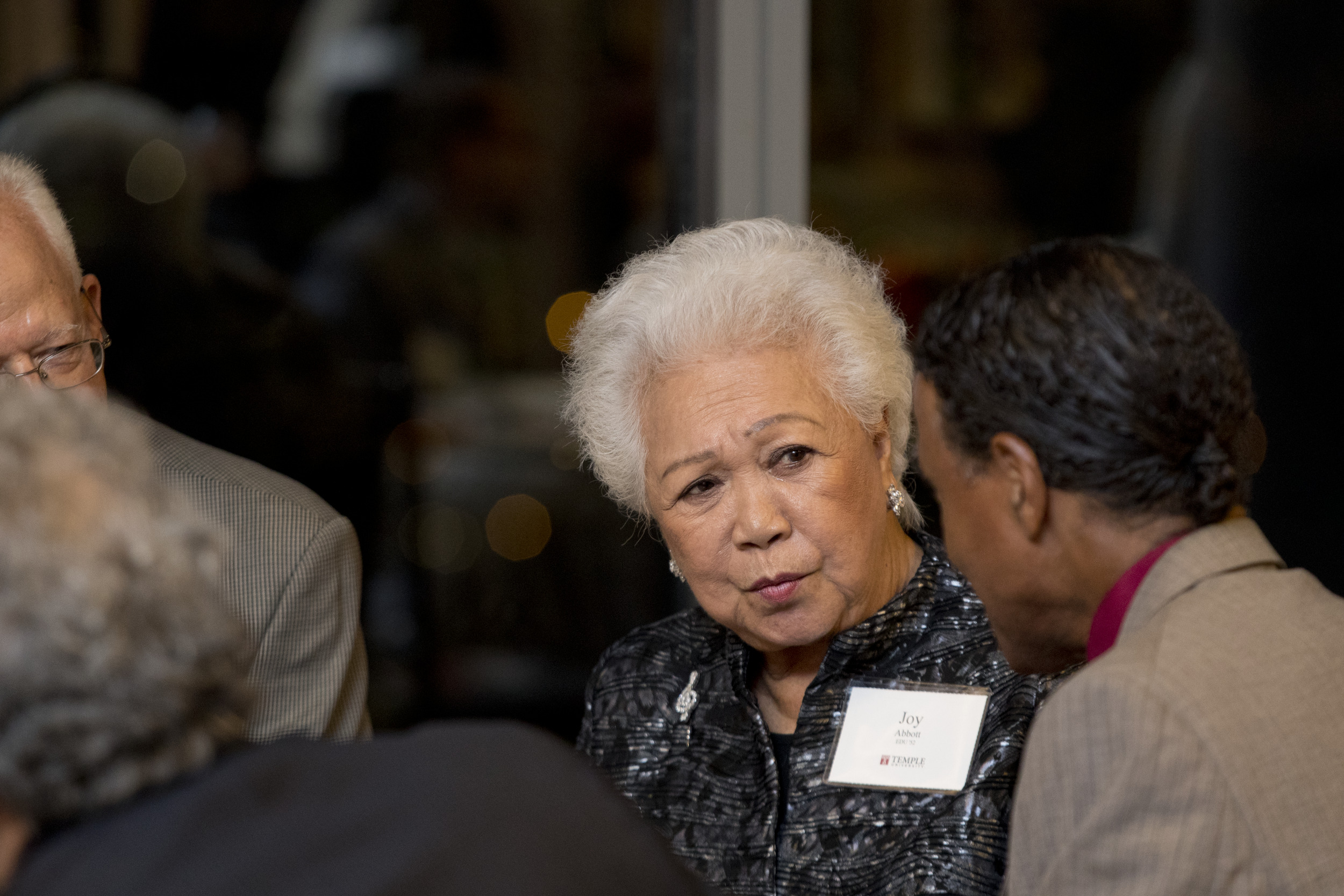 Image of Joy Abbott speaking with other people.