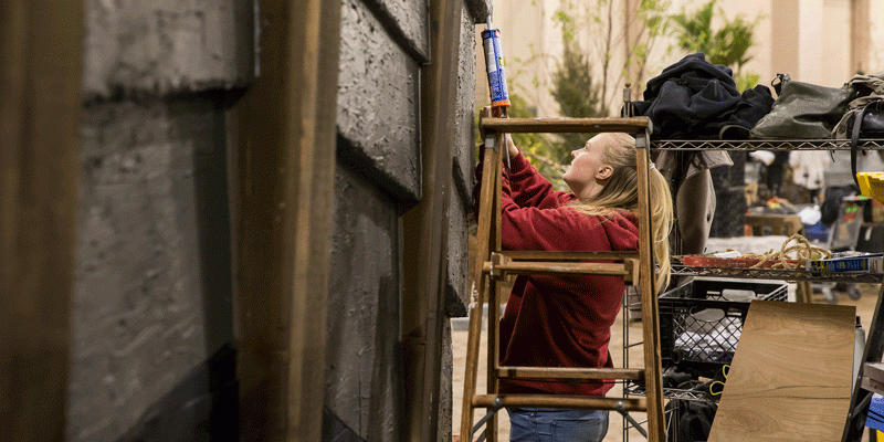 A Temple student working on the Flower Show exhibit