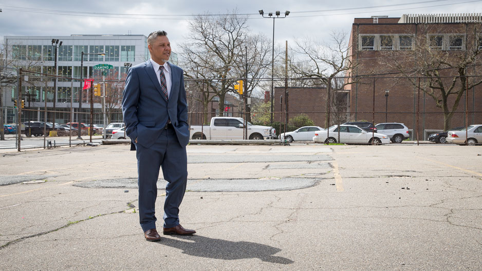 Gregory Anderson standing at the site of the proposed Alpha Center