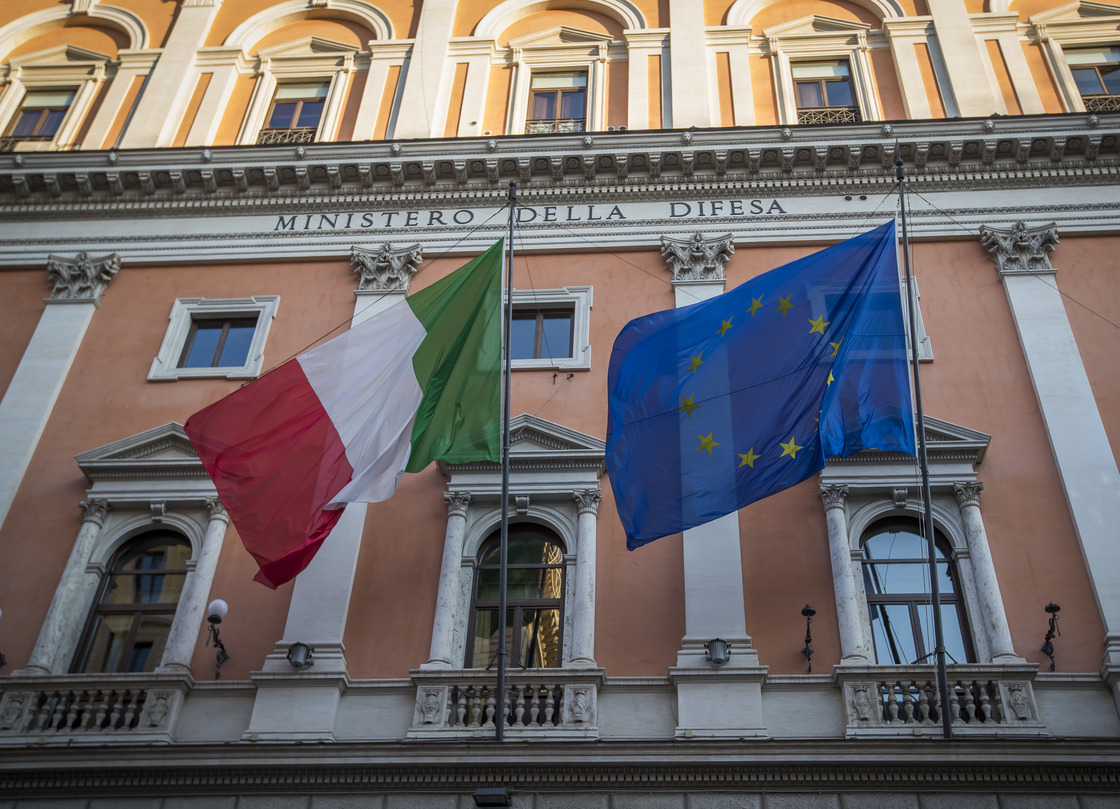 Image of the Italian and European flags on a building.