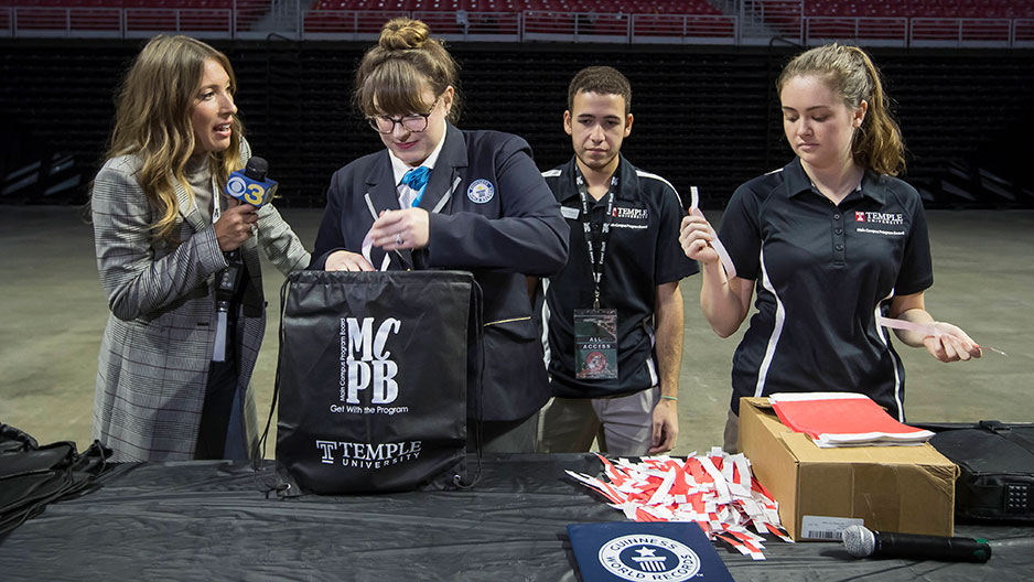 A Guinness judge examining backpacks