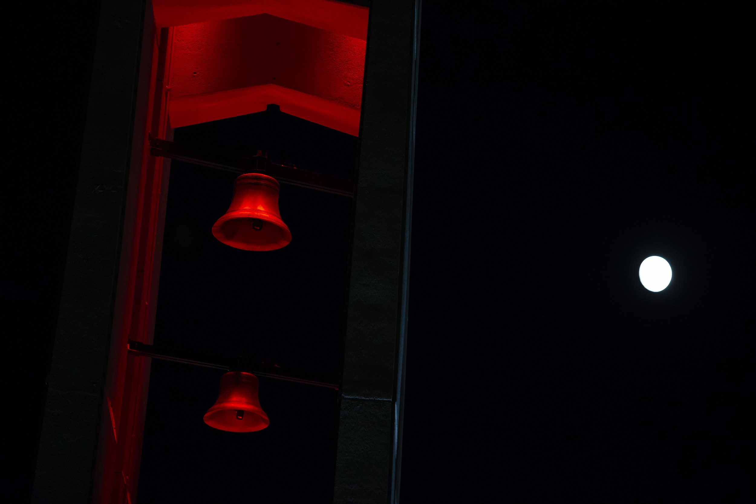 The moon shining above the Bell Tower on Main Campus.