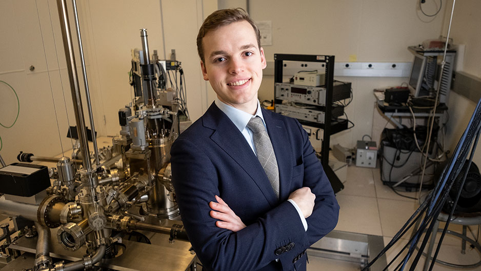 Marcus Forst, a senior physics major, stands in an applied physics lab