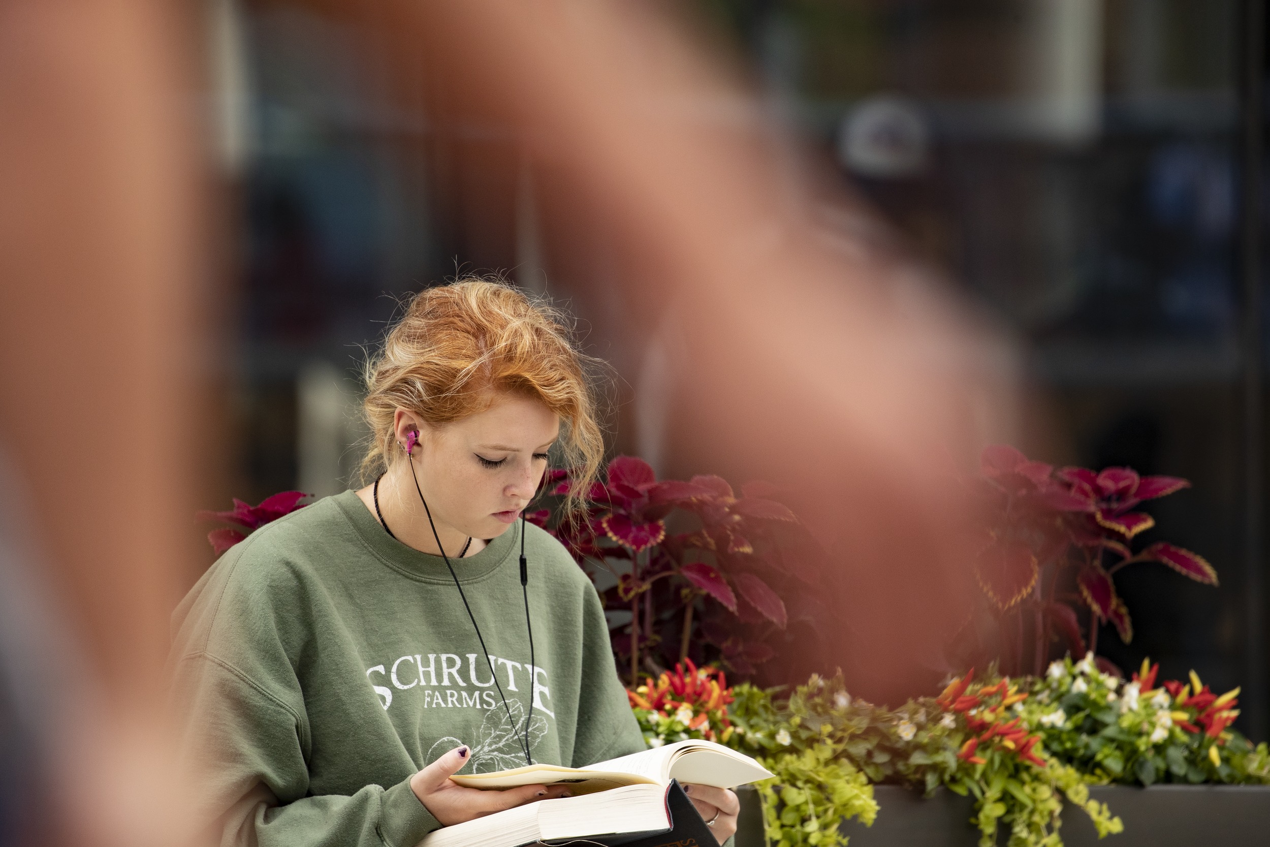 A student reading outside Charles Library