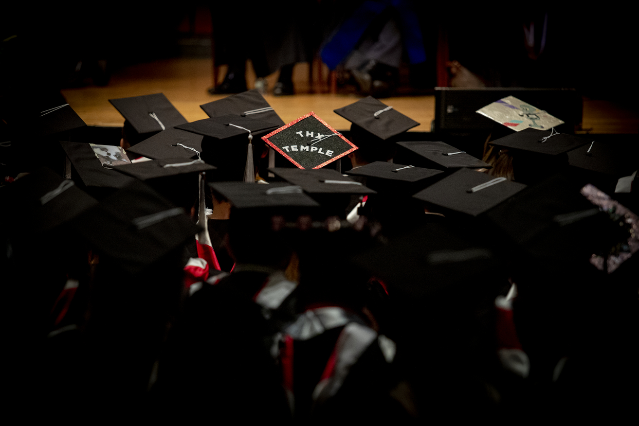 Image of Temple graduates in their graduation caps.