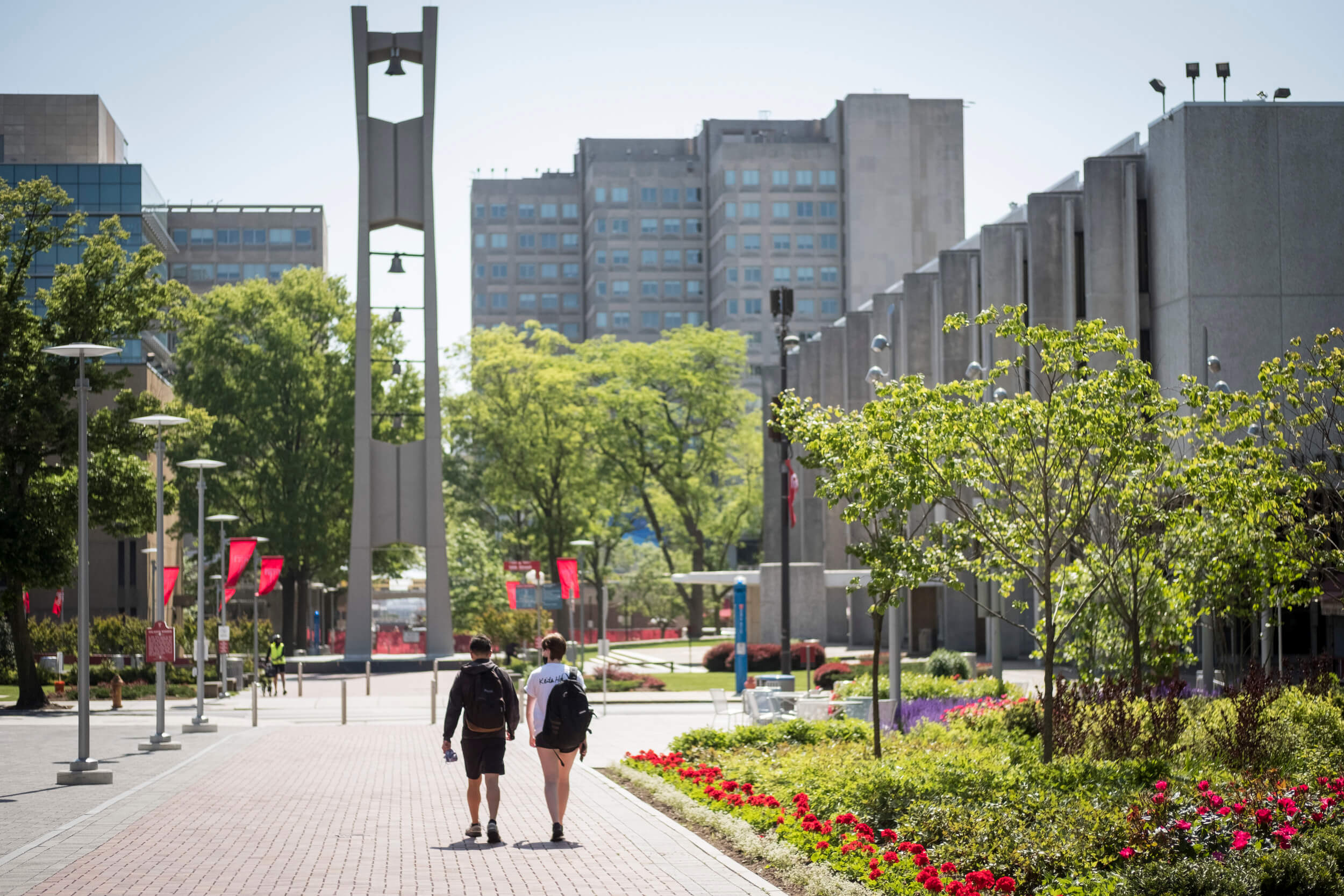 Students walk towards the Bell Tower on Main Campus.