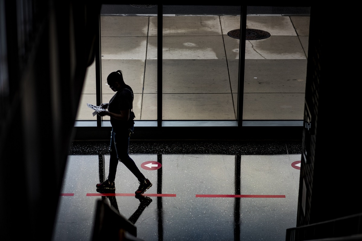 A person in silhouette walking through Morgan Hall.