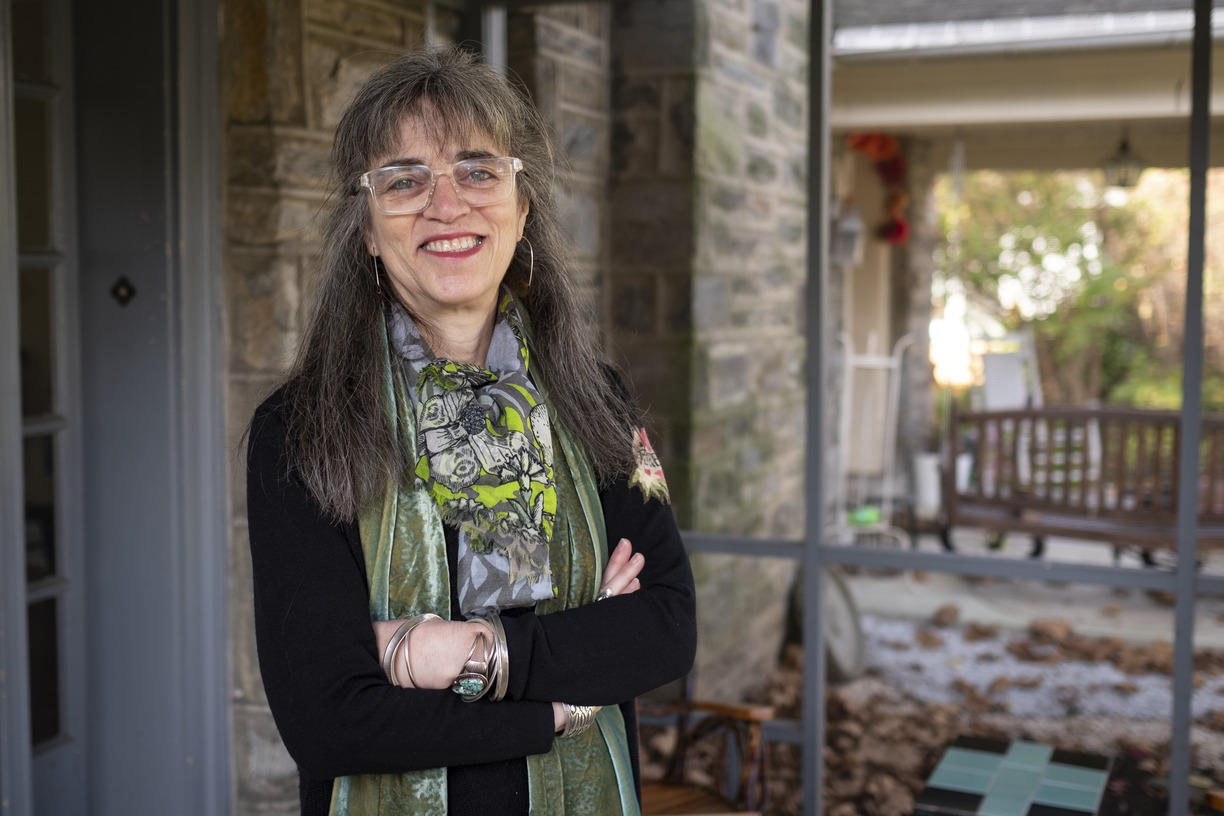 Author and Temple Professor Laura Levitt stands on the front porch of her home.