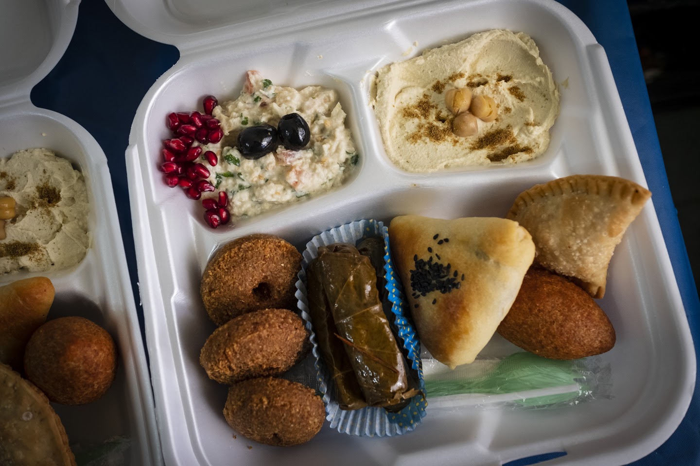 Image of Takeout containers of Syrian delicacies were distributed to guests of a virtual dinner.