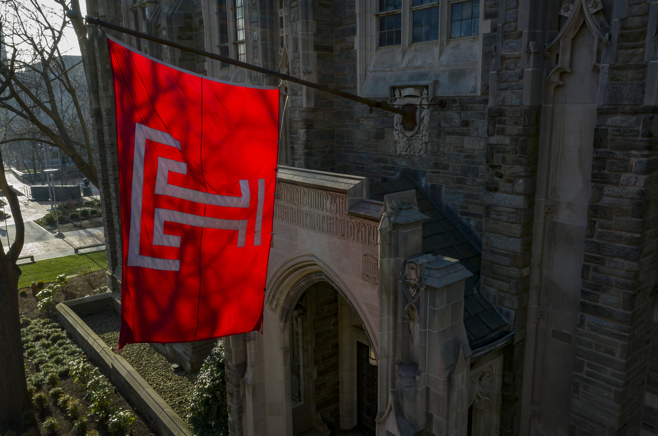 Temple University flag flying in front of Sullivan Hall