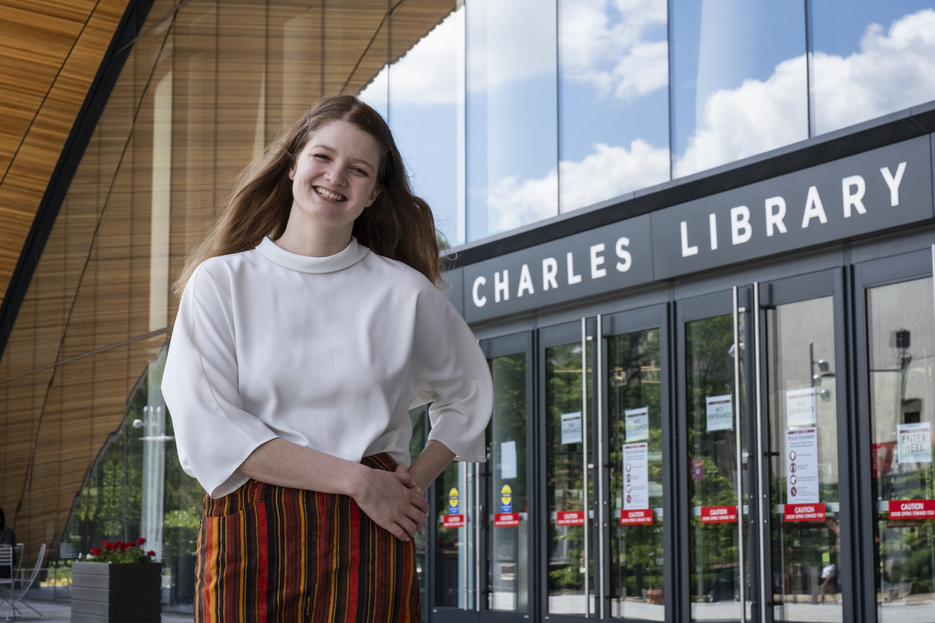 Kirtney Metz standing in front of Charles Library