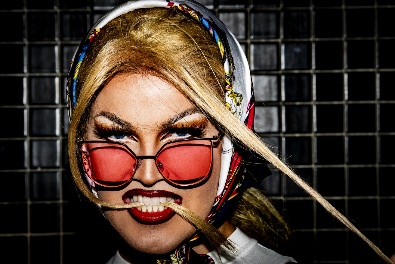 Dockery wearing pink sunglasses and striking makeup as Ruth Canal.