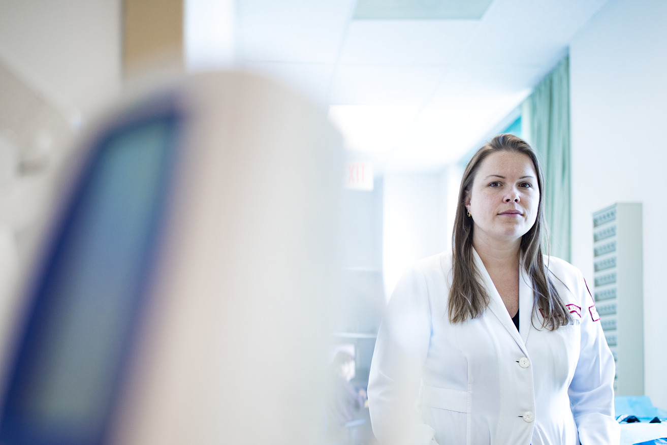 Jessica Beard wearing her white coat inside her medical clinic