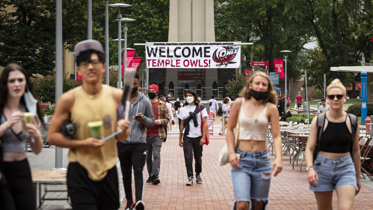 Students walking in front of the Bell Tower on Main Campus.