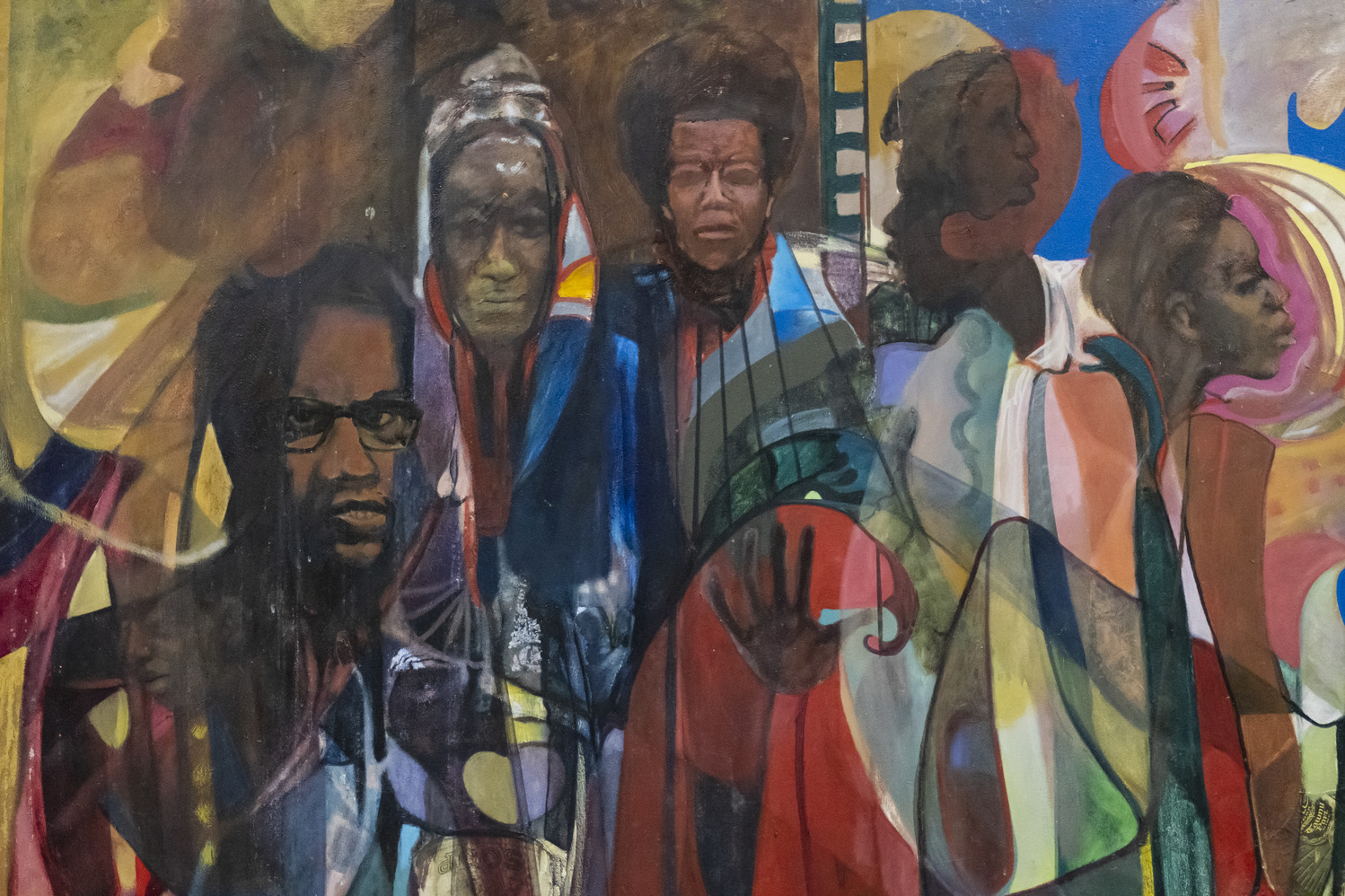 A painting of Black civil rights leaders faces with a mixture of cool and warm colors intersecting on top and around each face.