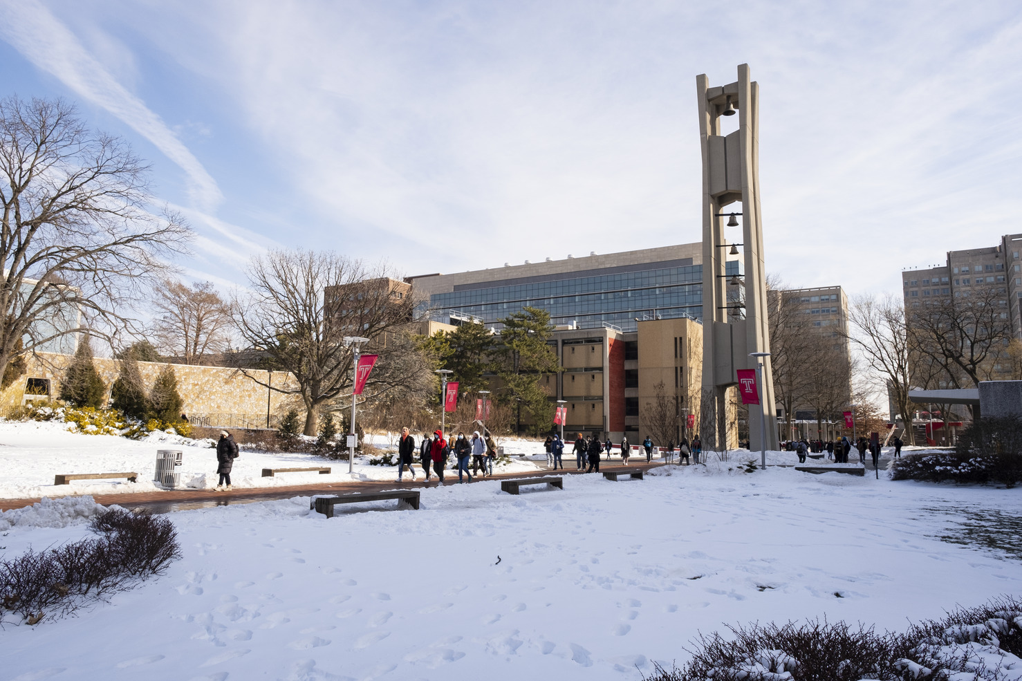 Students walking outside in the snow near the Bell Tower.