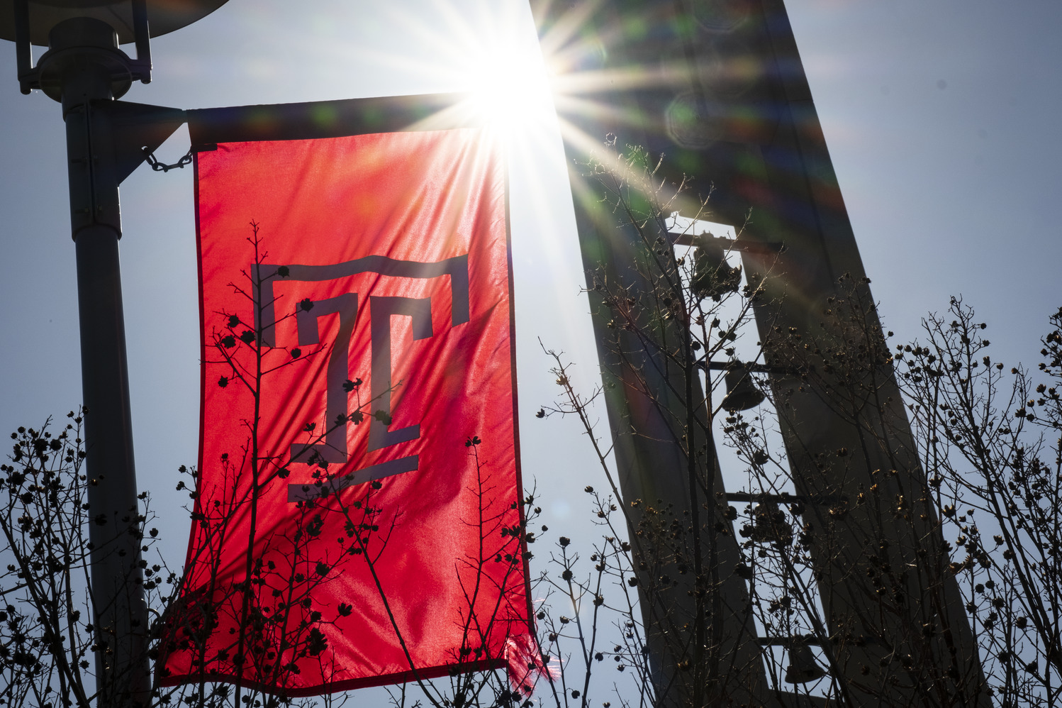 Campus stock of the Bell Tower and a Temple flag.