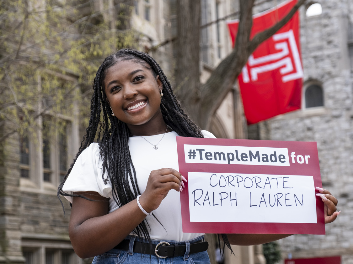 Rachel Edwards holds a sign reading Temple Made for Ralph Lauren