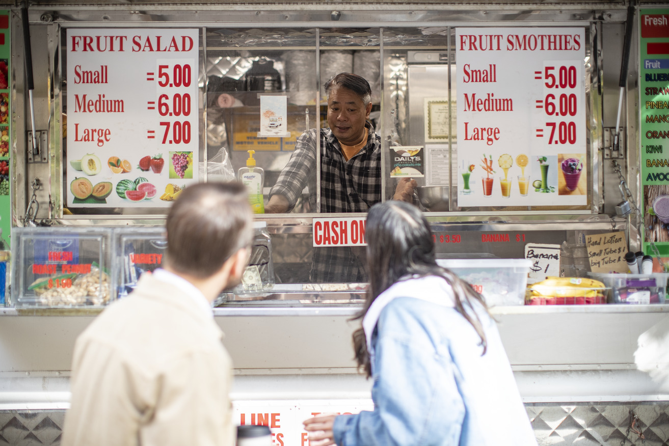 Image of students interviewing a food truck operator.