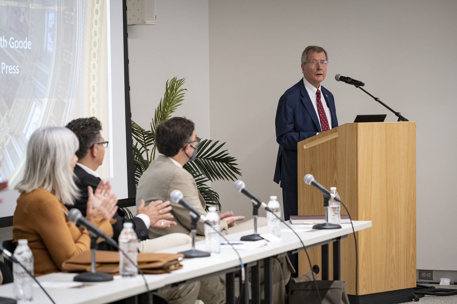 Richard Englert at a podium speaking during a Temple Press event.