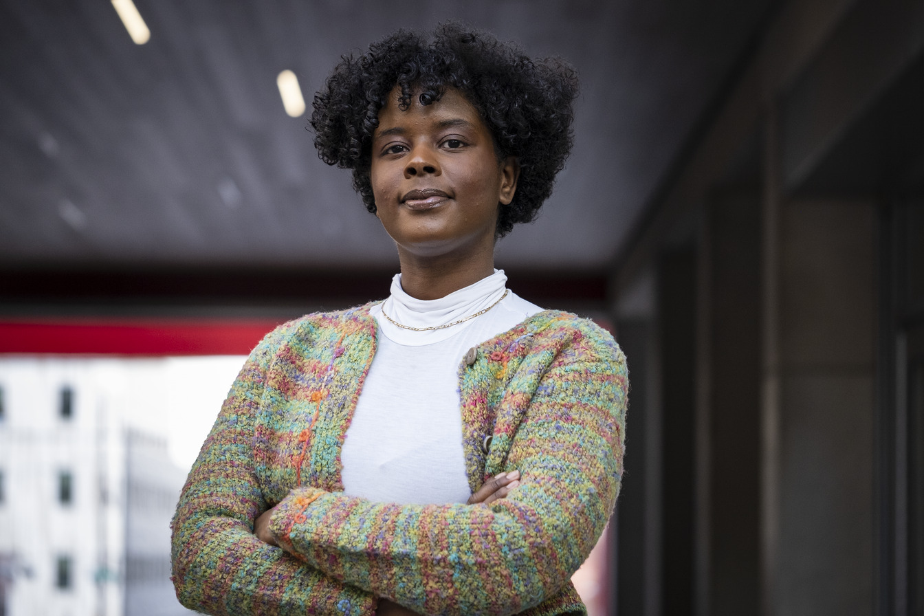 Jazmin Evans standing with her arms crossed on campus