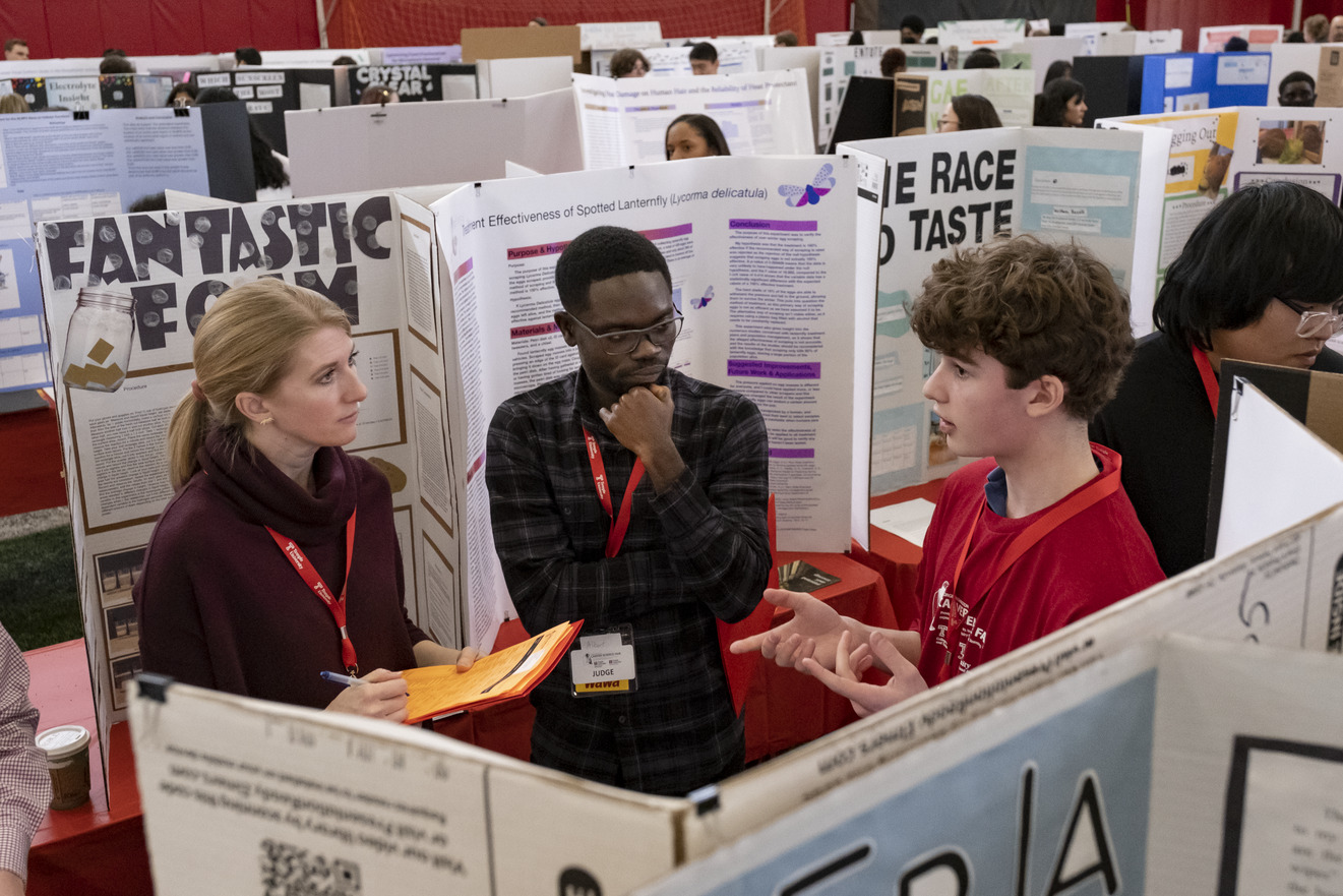 Judges and a student at the science fair
