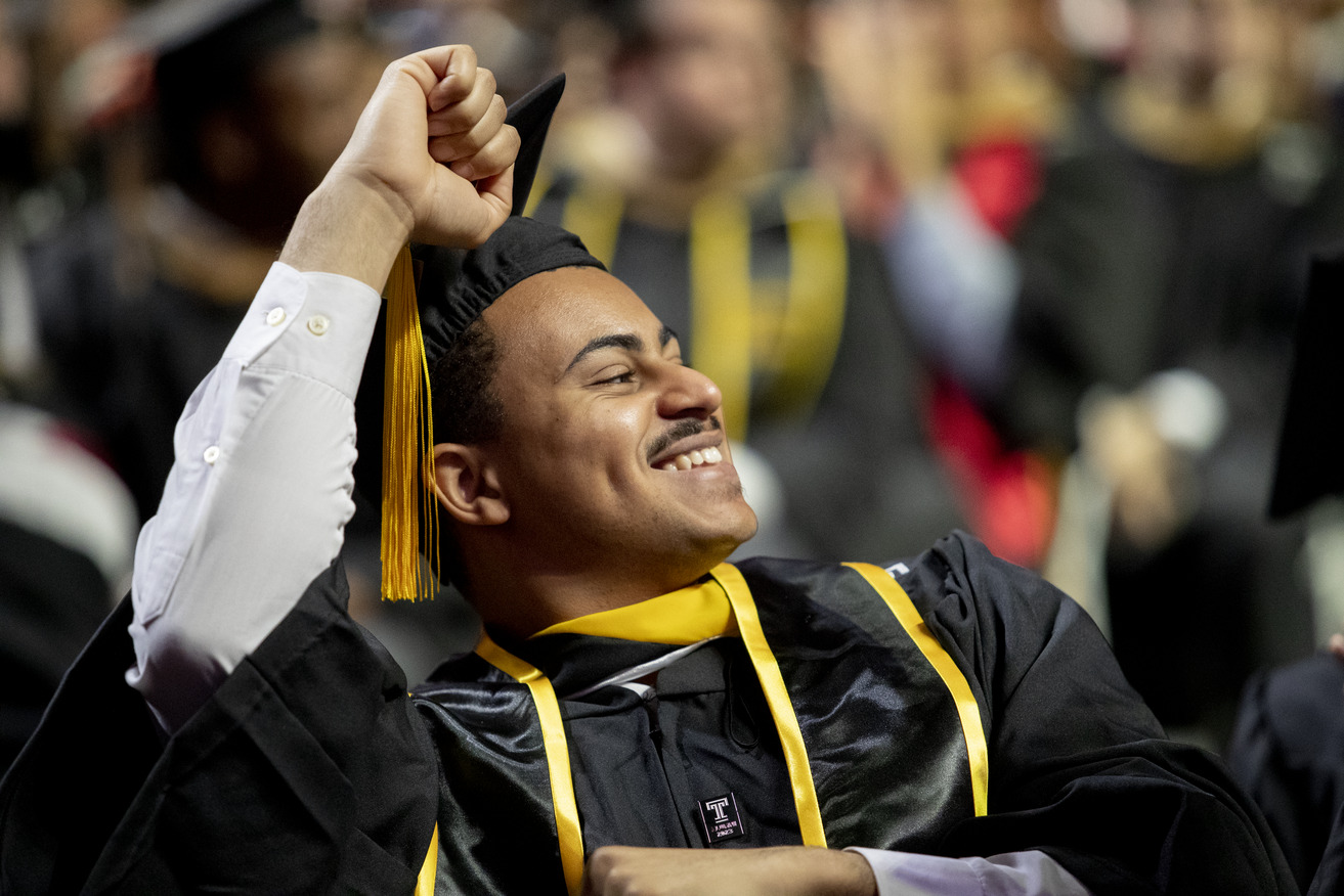 Student at Commencement pumping his hand in the air