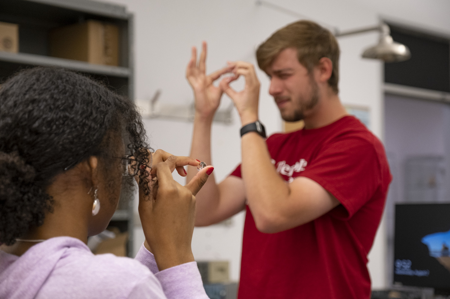 A CST student works with a high school student