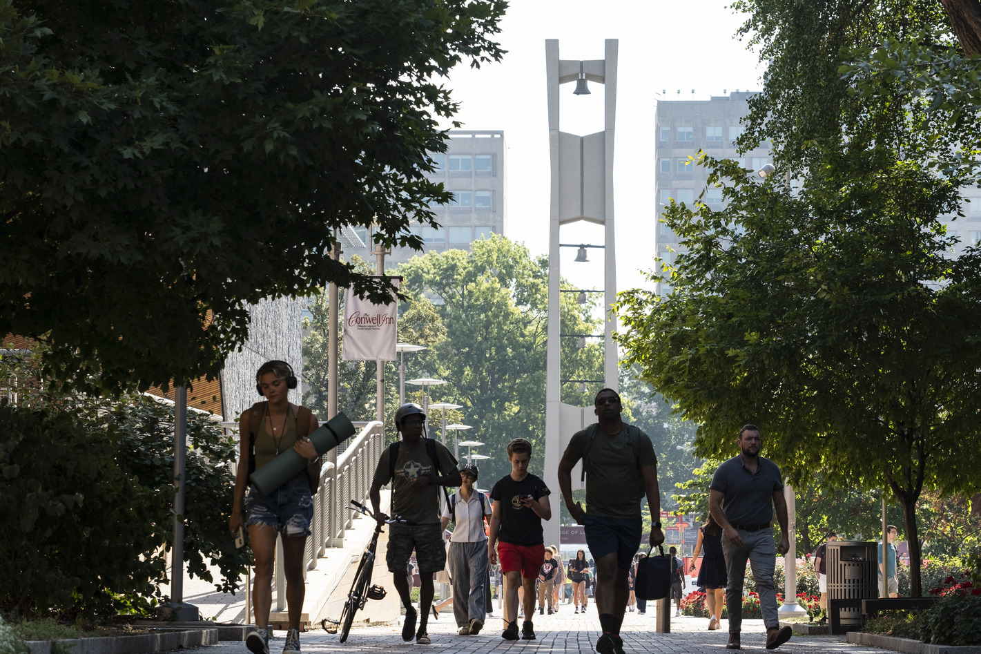 Students walking with the Bell Tower in the background