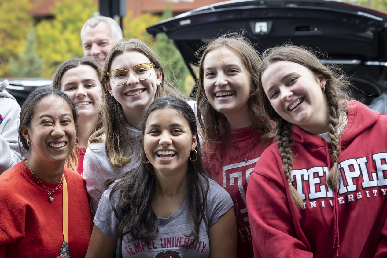 Temple students wearing Temple logo gear.