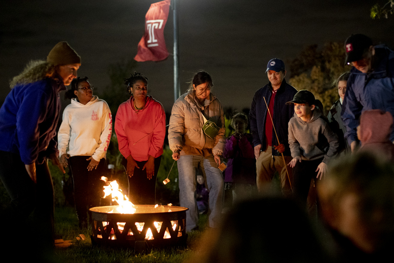 Attendees roasting marshmallows.