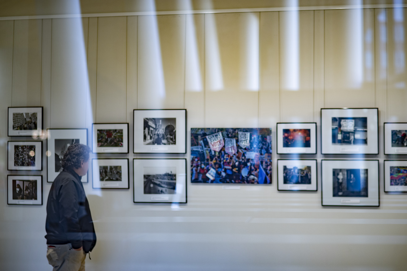 Image of a photo exhibit in a white room on the first floor of Charles Library at Temple University.