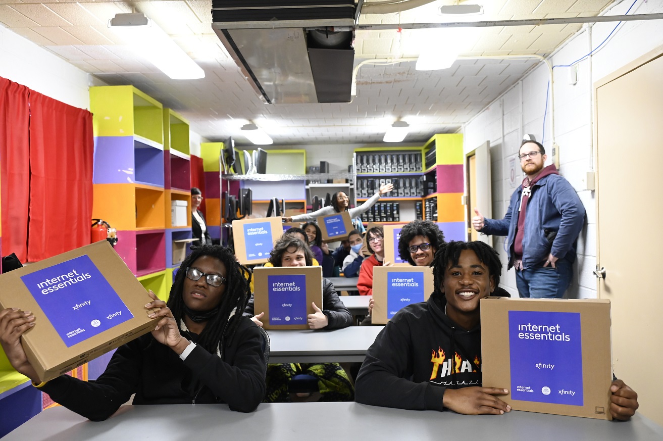 North Philadelphia youth smile for cameras inside Temple University s Digital Equity Center.