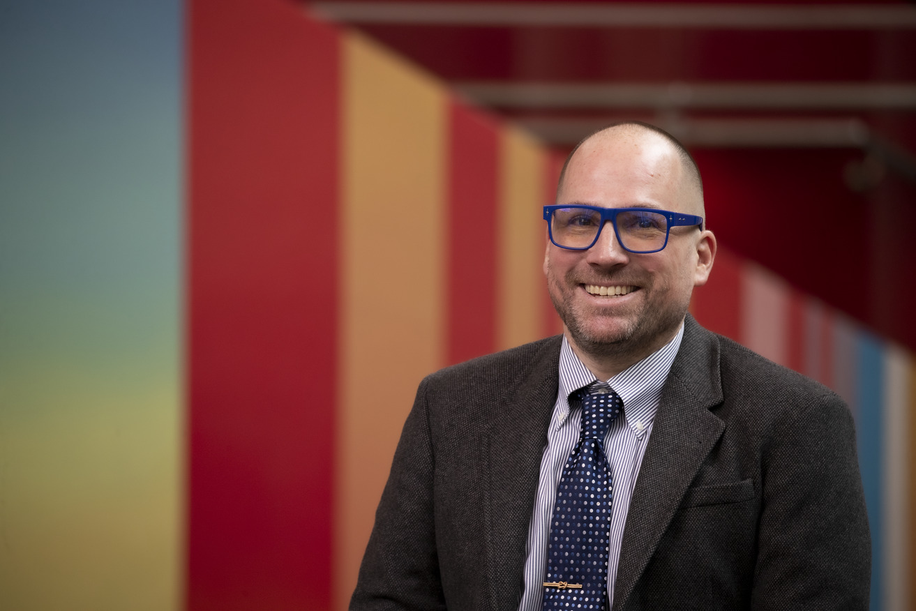 Dustin Kidd wearing blue glasses