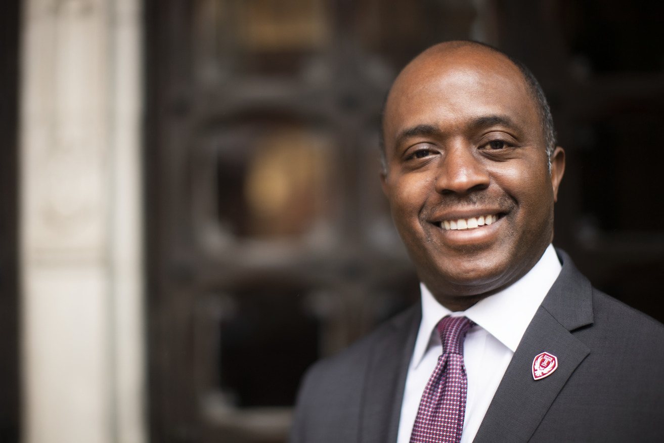 mage of Tony Thurmond in a suit and tie with an Owlmark lapel pin.