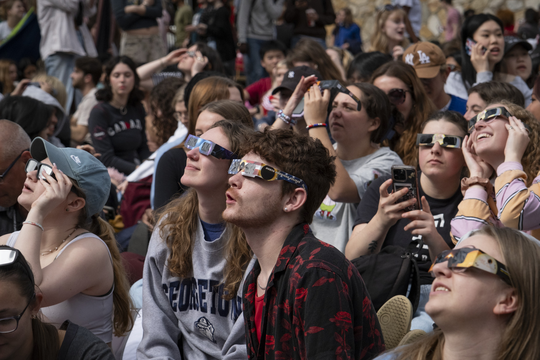 Image of students wearing eclipse glasses to view the April 8 solar eclipse.