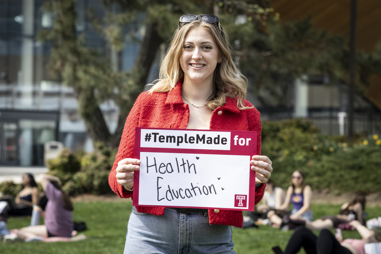 Meredith Kearney holding a Temple Made for sign