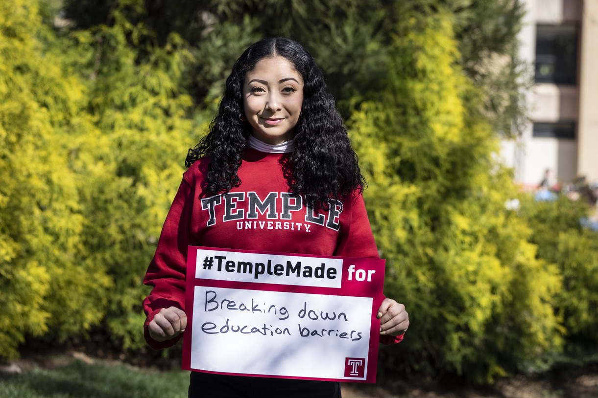 Evelyn Lara holding a Temple Made sign